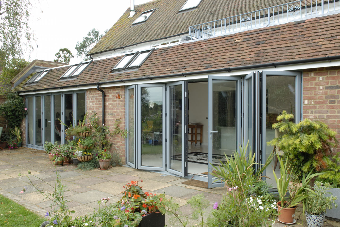 Bifolding doors on an older property, looking from the garden