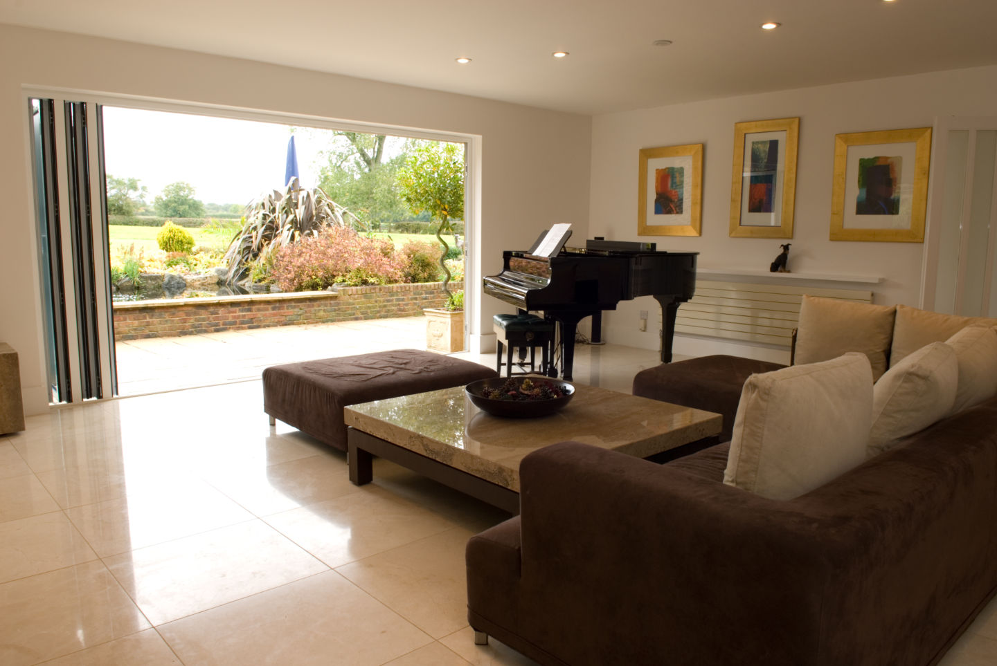 Bifolding doors in a classy living room with a grand piano
